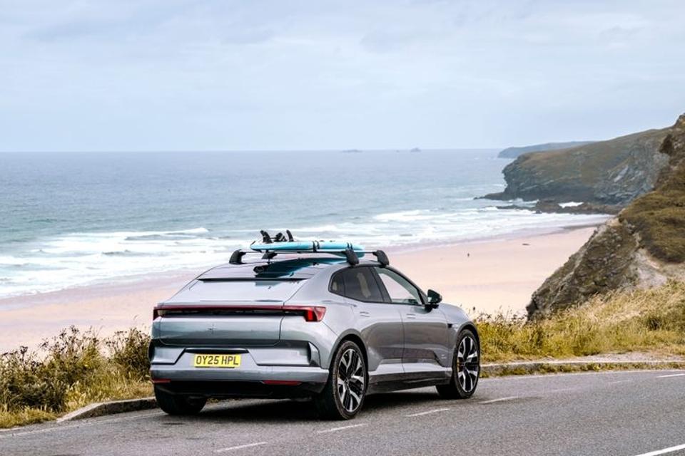 Polestar 4 parked cliffside with a surfboard on top