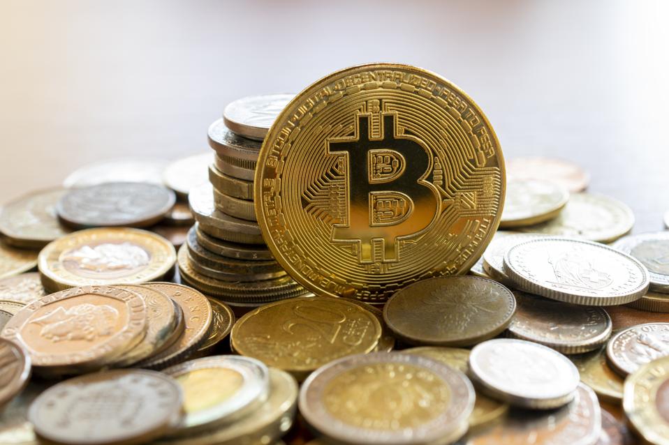 bitcon coin in the middle of multiple coins. cryptocurrency concept