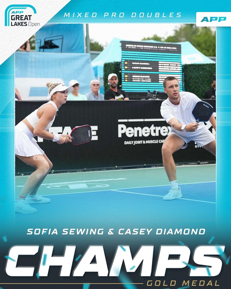 Two athletes shaking hands on a pickleball court