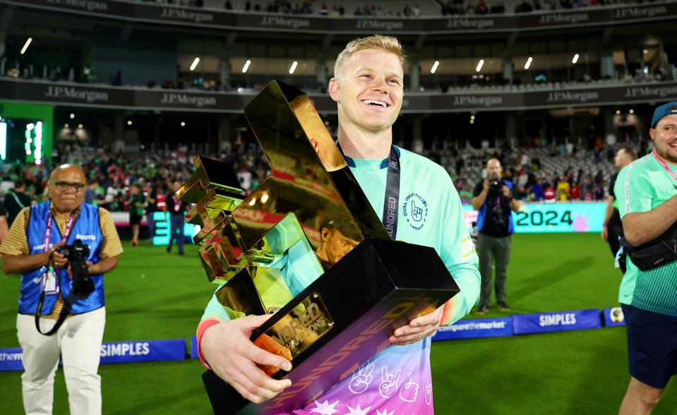 Sam Billings holds the 2024 Hundred trophy after the Oval Invincibles beat Southern Brave.