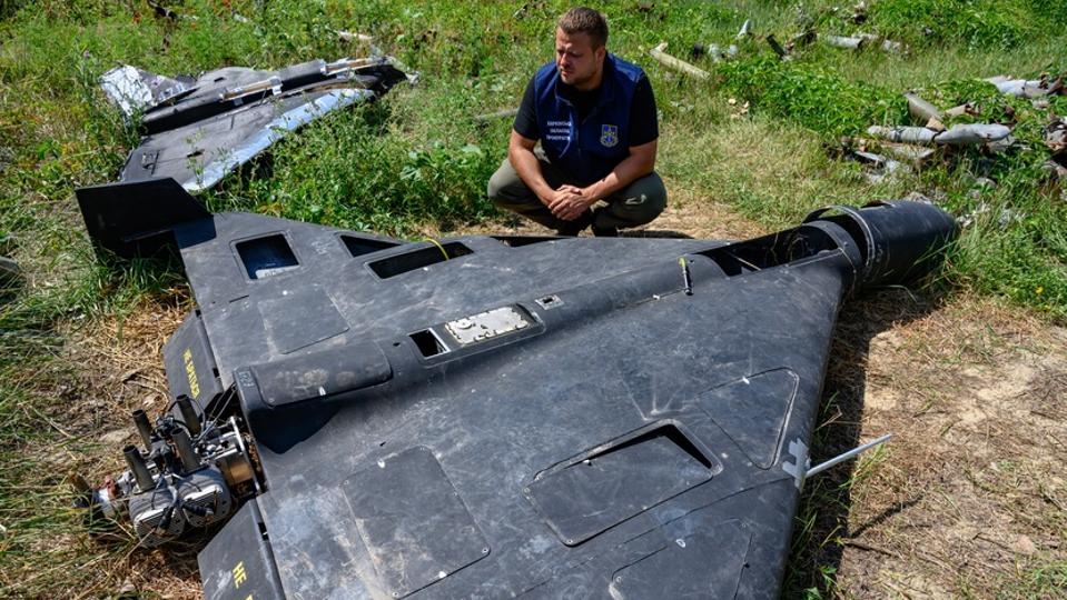 Ukrainian prosecutor examining a Shahed-136 drone
