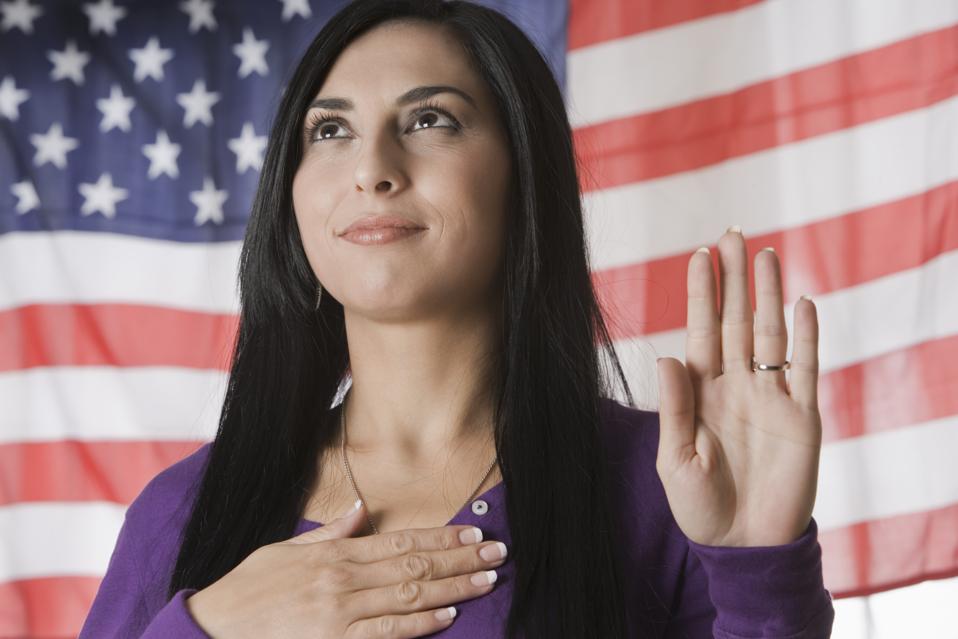 A Turkish woman takes the Oath of Allegiance to America. A new test of moral character is required.