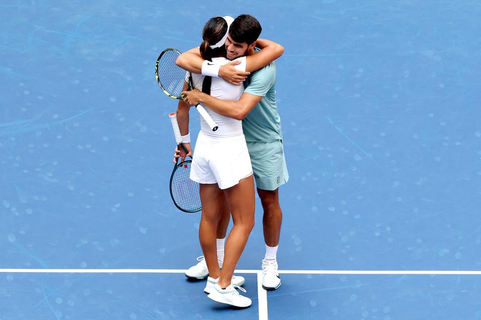 Carlos Alcaraz and Emma Raducanu embrace after their defeat in the U.S. Open Mixed Doubles