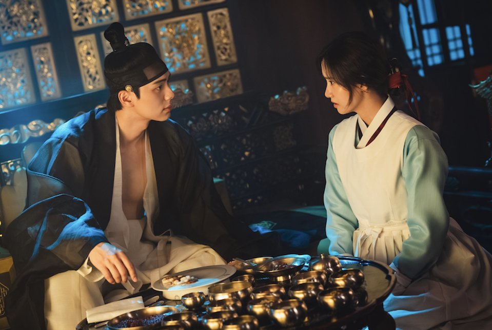 A Joseon era king and his chef sit down before a meal of many dishes.
