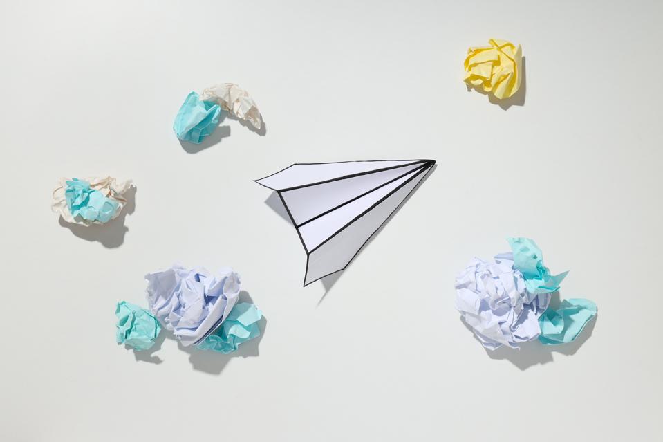 paper-plane-and-paper-balls-on-white-background-2025-03-24-16-49-07-web