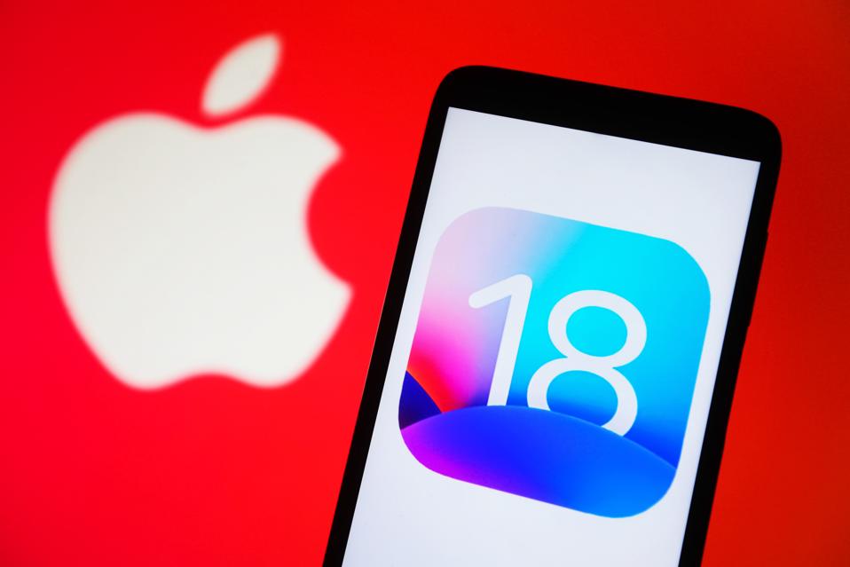 In this photo illustration, iOS 18 logo is seen on a...