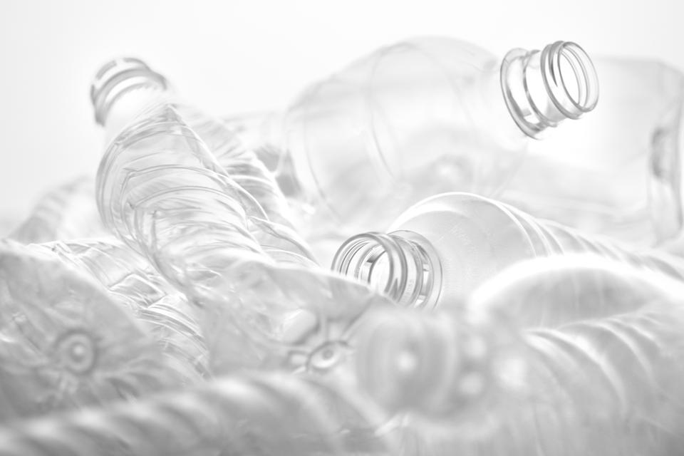 Many crushed plastic bottles placed on a white or transparent background
