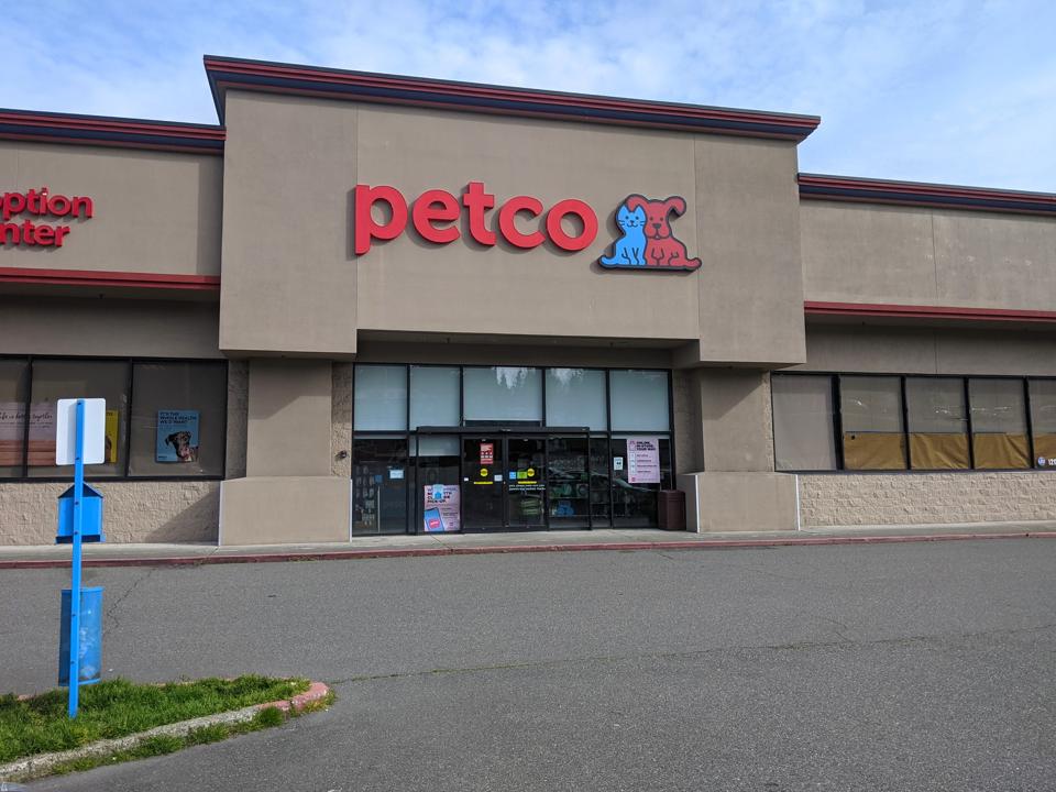 Street view of the entrance to a Petco pet supply store.