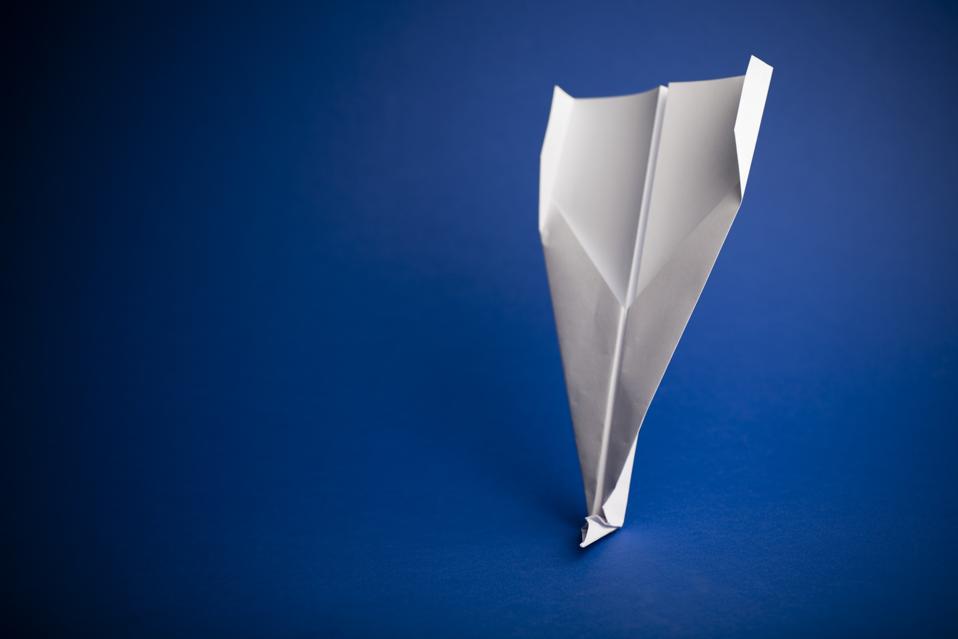 Paper airplane on blue background