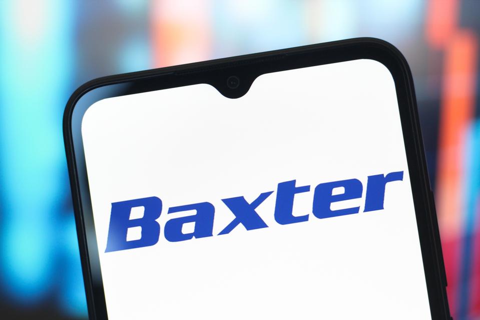 In this photo illustration, the Baxter International logo is...