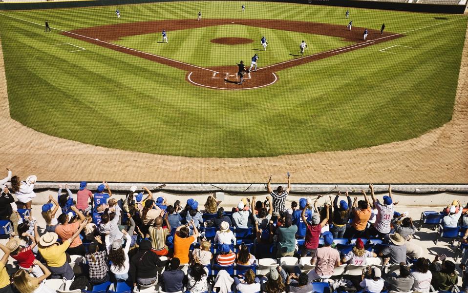 Wide shot rear view crowd cheering during professional baseball game
