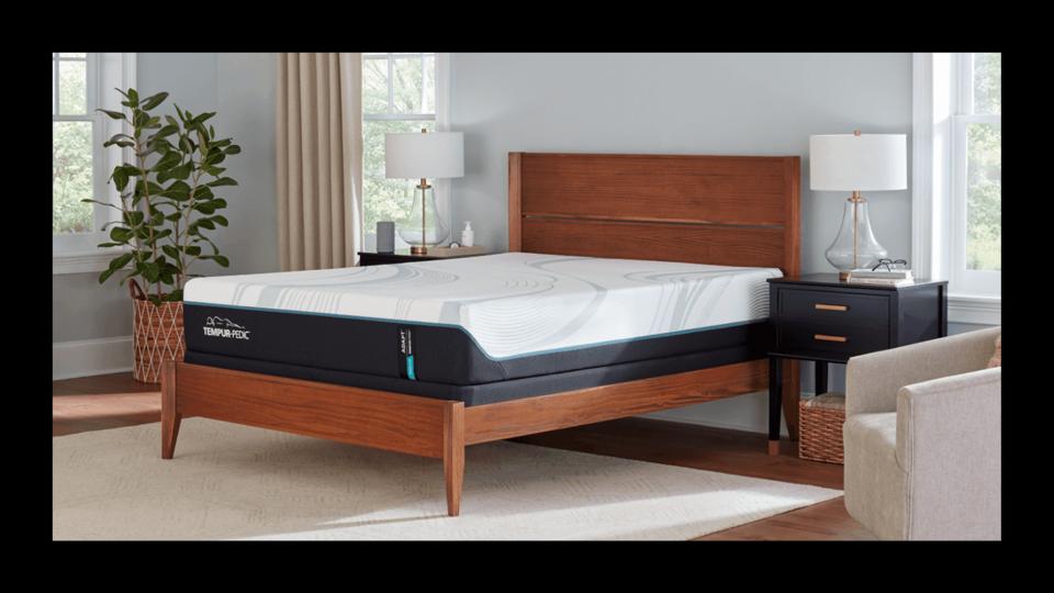 Tempur-Adapt bed on a wooden bed frame in a bedroom setup