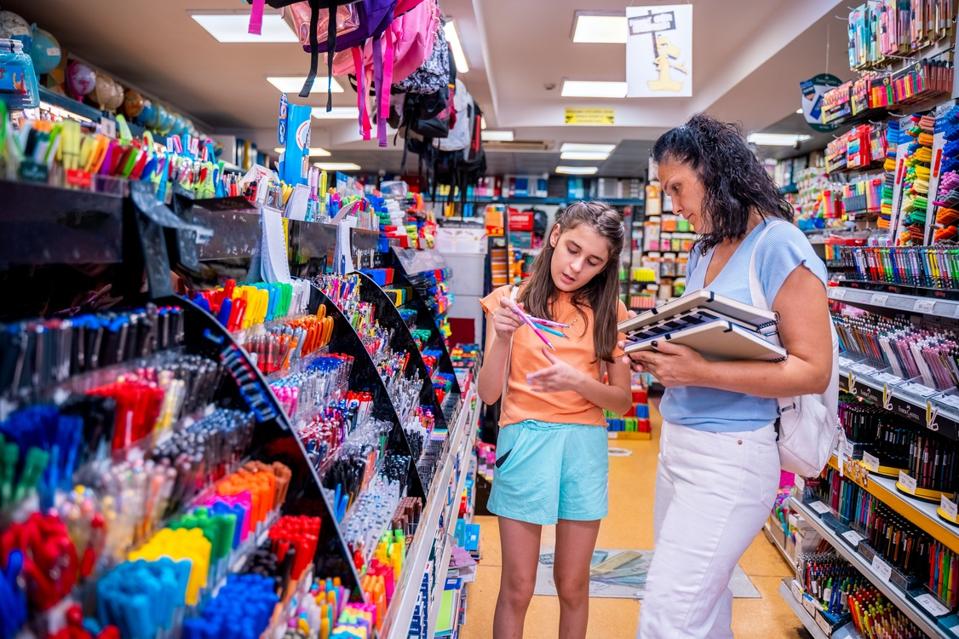 Mother and daughter shopping school supplies in a store