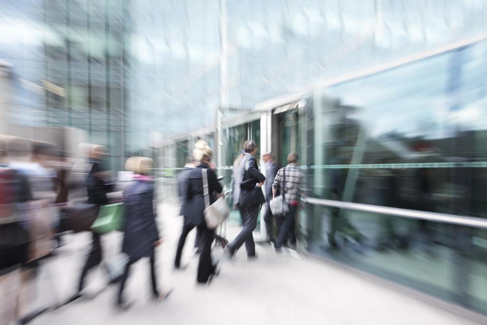Blurred View of Business People Walking in Financial District