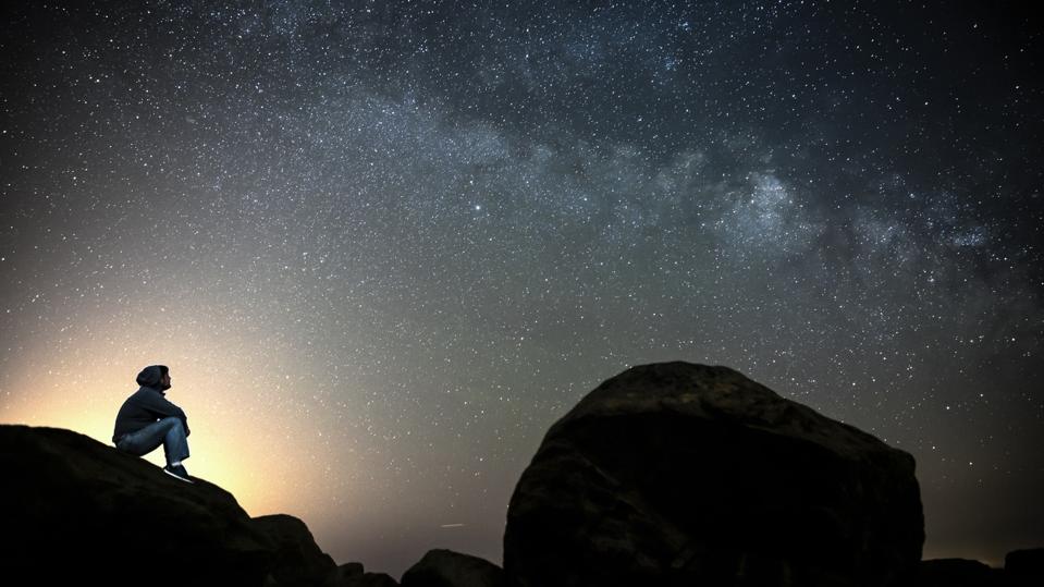 Man looking at the Milky Way galaxy