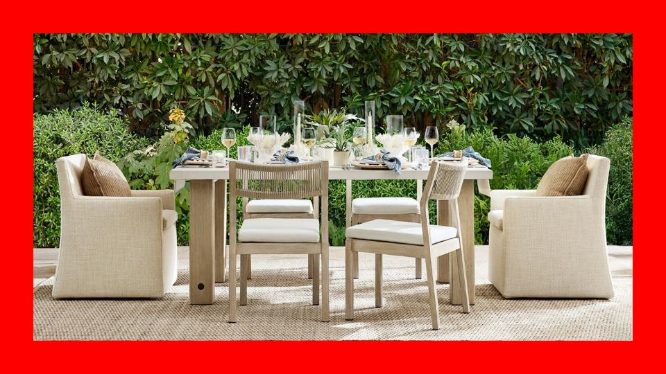 An outdoor dining set with green foliage in the background