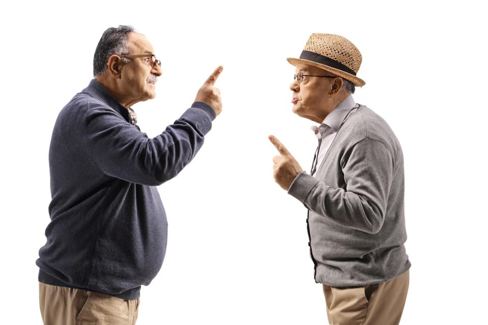Profile shot of two angry mature men having an argument