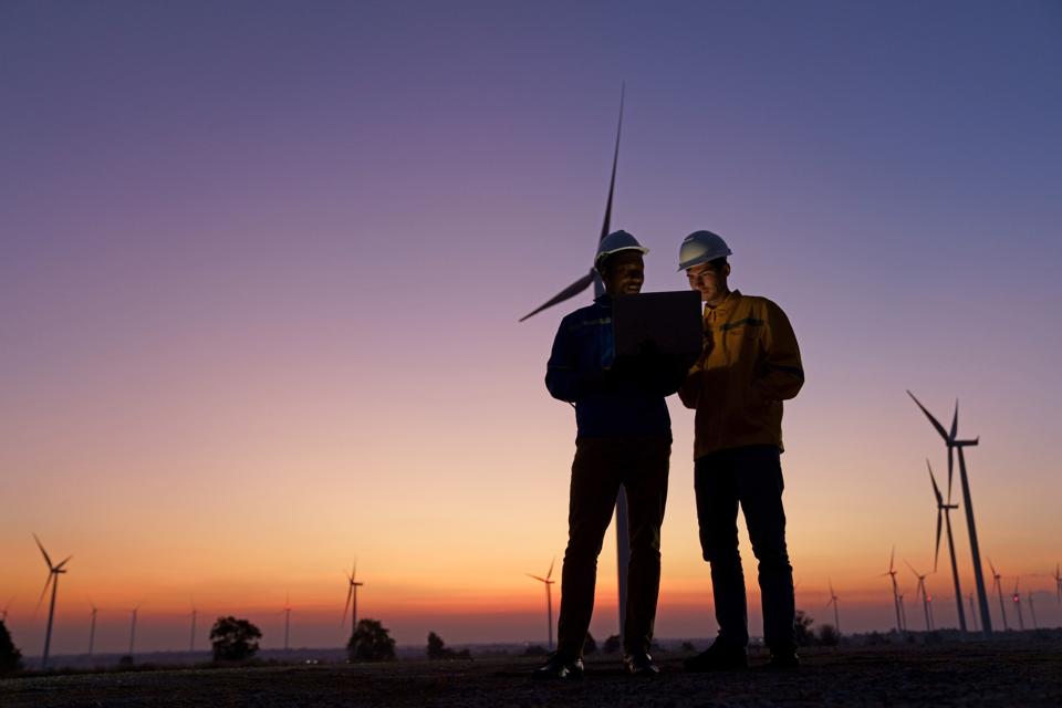 Wind turbine technicians remote operating test rotor blades at sites