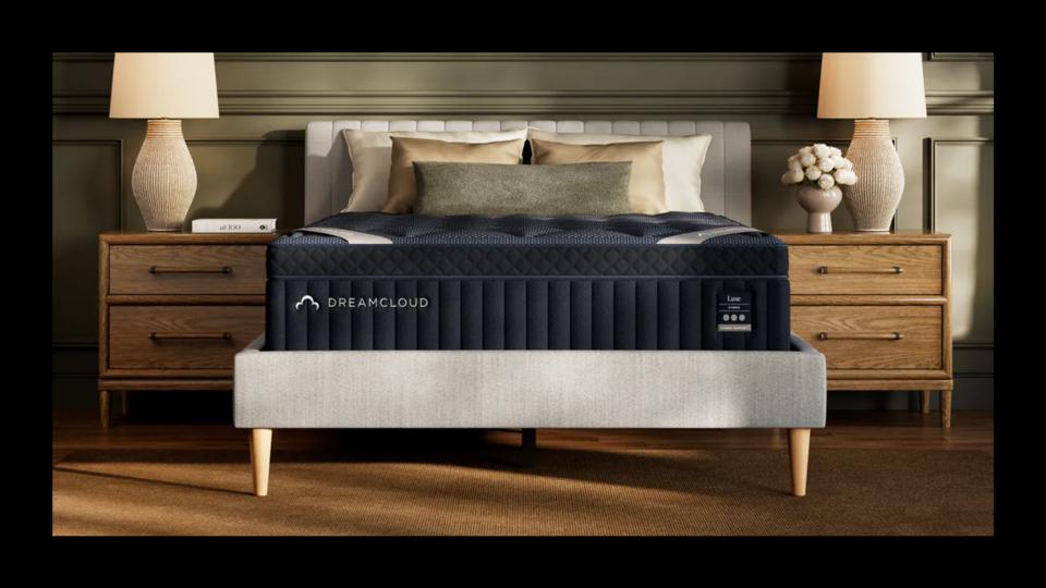 The DreamCloud Classic Hybrid Mattress in a decorated bedroom with a black border