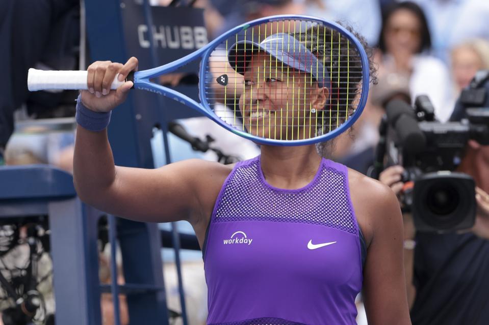 Naomi Osaka smiles after beating Coco Gauff in the fourth round of the U.S. Open.