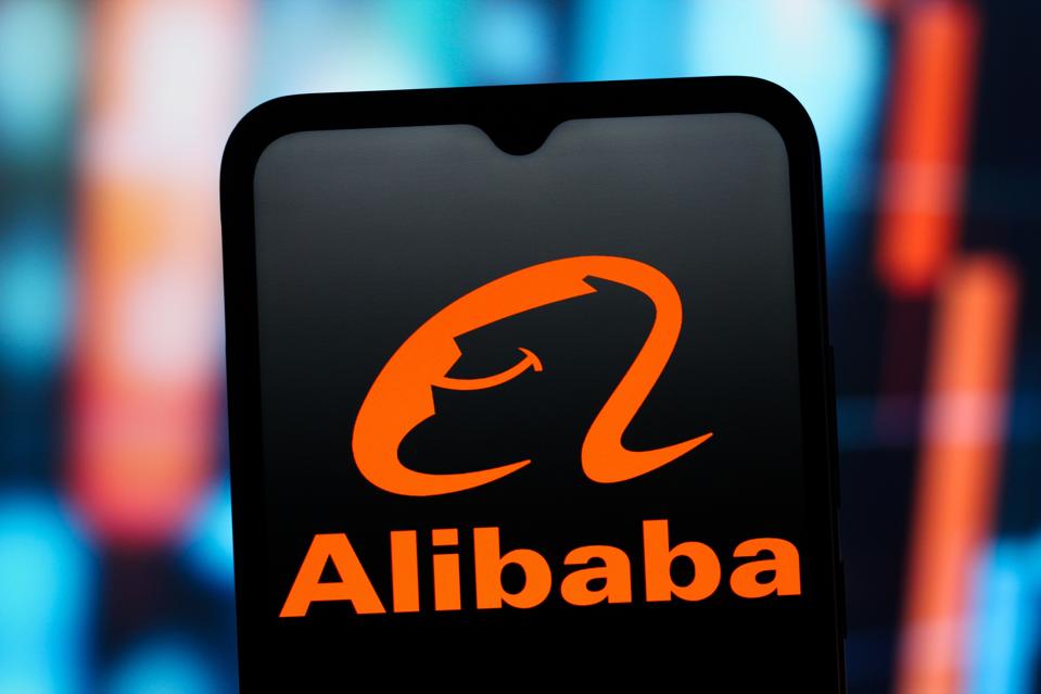 In this photo illustration, the Alibaba Group logo is seen...
