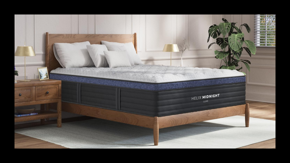 Lifestyle image of the Helix Midnight Luxe mattress in a bedroom