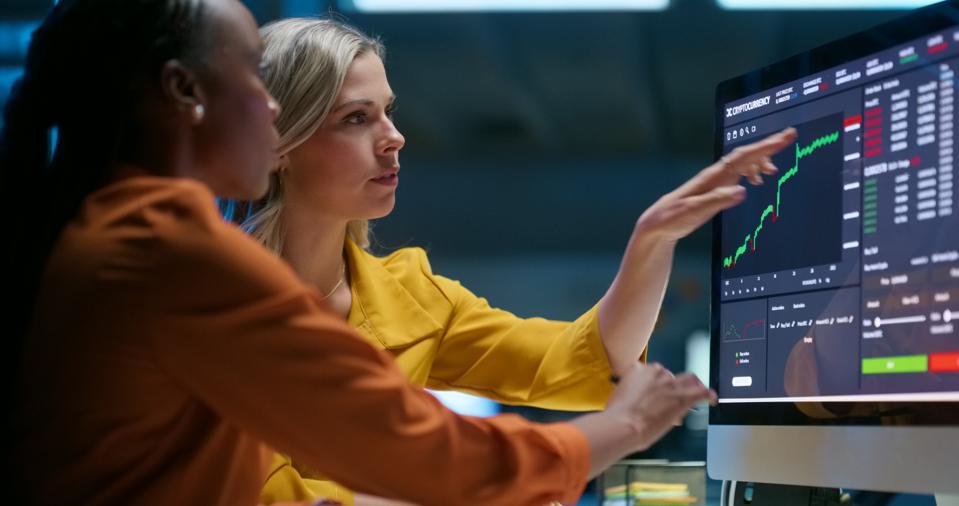 Business people, computer and screen with stock market, teamwork and connection with internet, trading and charts. Staff, investor and women with a pc, cooperation and fintech with finance and graphs
