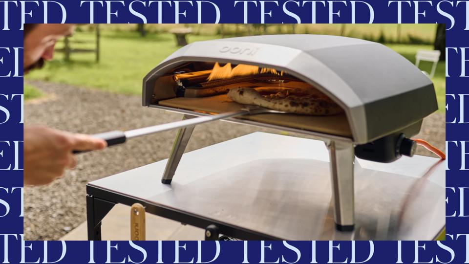Person using pizza peel to turn pizza in Ooni oven