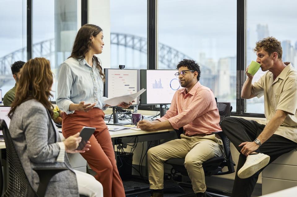 Corporate professionals sharing ideas in team meeting