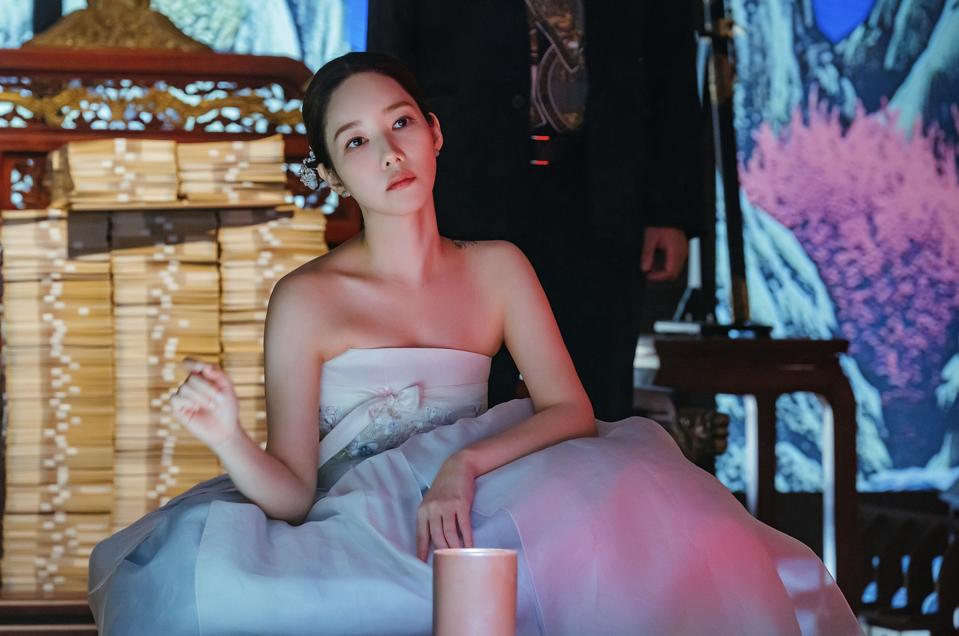 Actress Park Min Young wearing a white shoulder less dress.