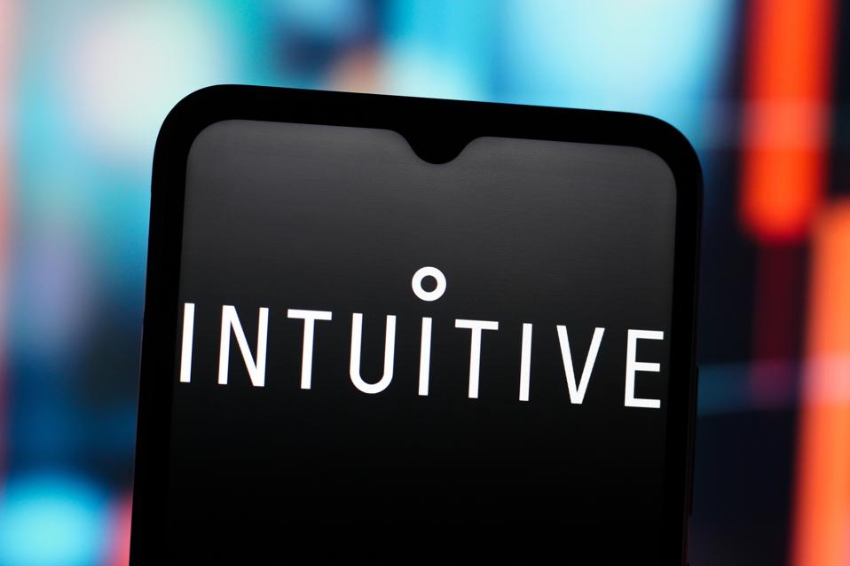In this photo illustration, the Intuitive Surgical logo is...