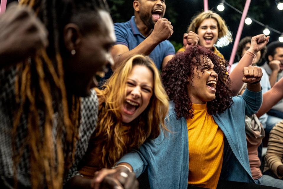 Friends watching a sports game and open-air glory