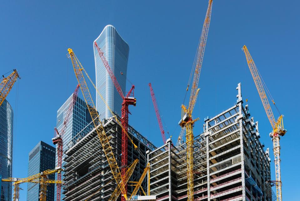 Construction and tall cranes building large structure in Beijing, China