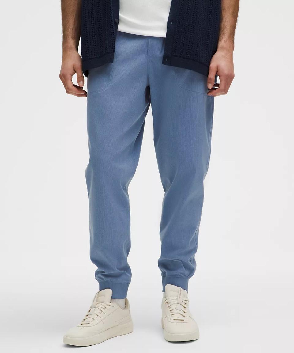 A man wearing blue Lululemon ABC WovenAir Joggers