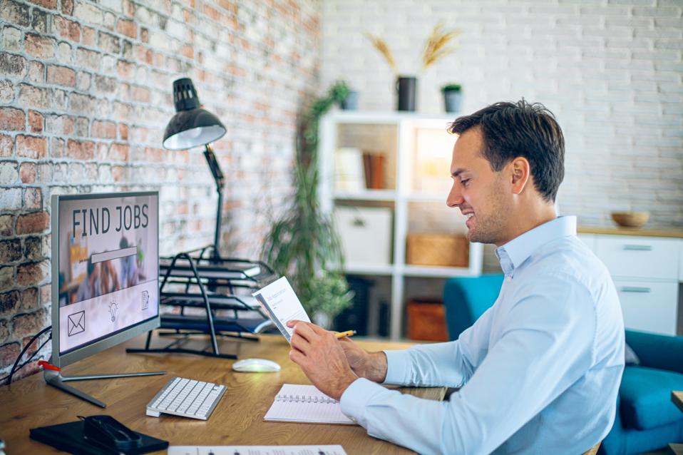 Man holding his resume, while searching a new job
