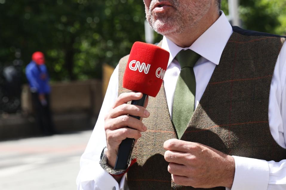 CNN news reporter holding a microphone