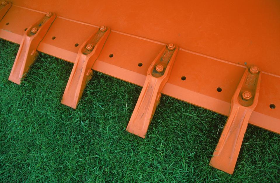 Detail of teeth at front of excavator or loader bucket.