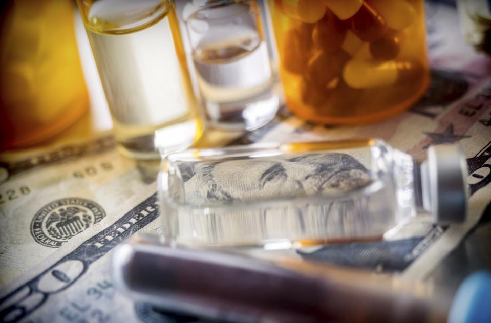 vials with different substances over dollar, concept of copayment