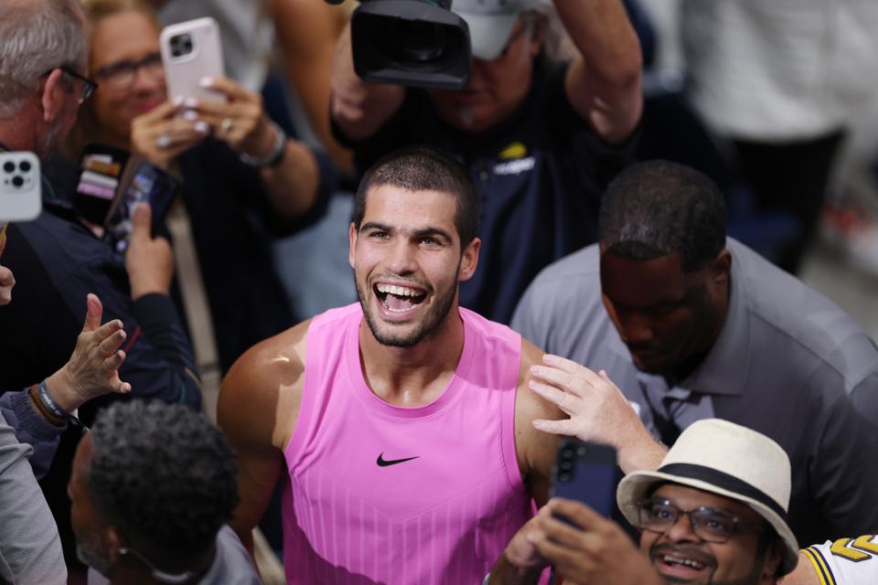 Carlos Alcaraz beams after beating Jannik Sinner in the US Open final at Flushing Meadows.