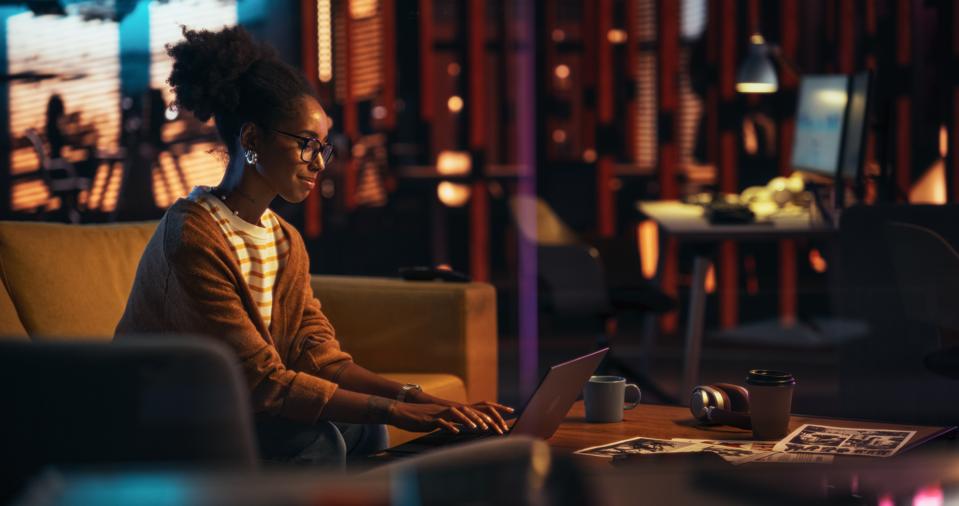 Portrait of Black Female Working in Empty Creative Agency, Implementing Modern Business Strategy for Clients. Successful Game Developer Using Laptop Computer at Night in the Office