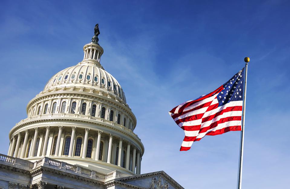 American flag waving with the US Capitol Building