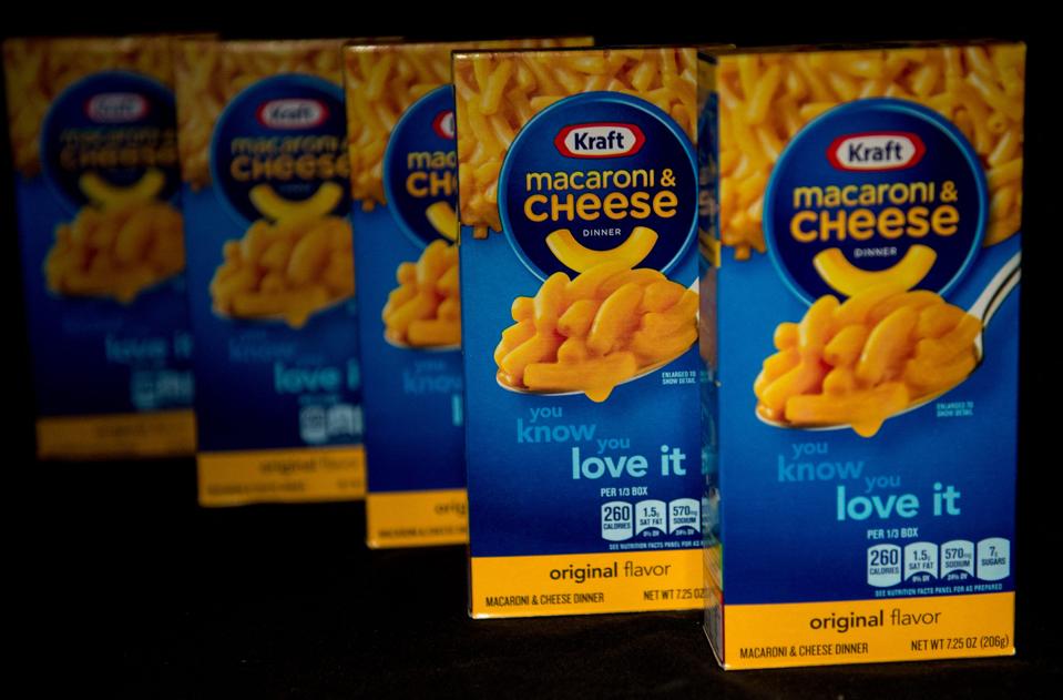 Packages of Kraft Macaroni & Cheese on grocery shelf.