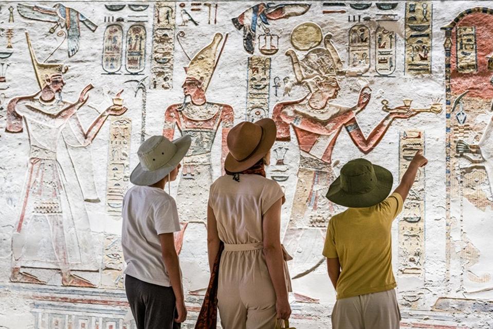 Family admiring art inside Ramses IX Tomb, Luxor