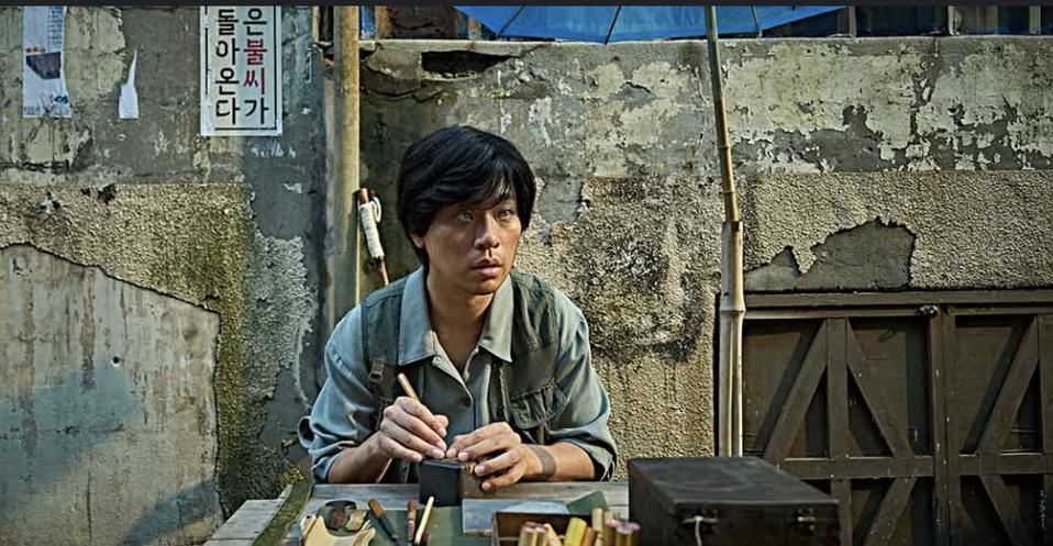 A blind man crafts a seal.