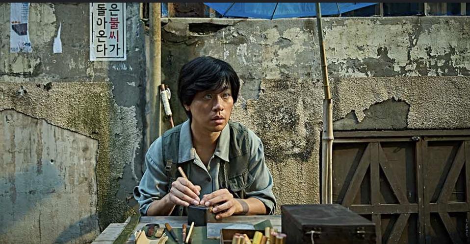 A blind man crafts a seal.