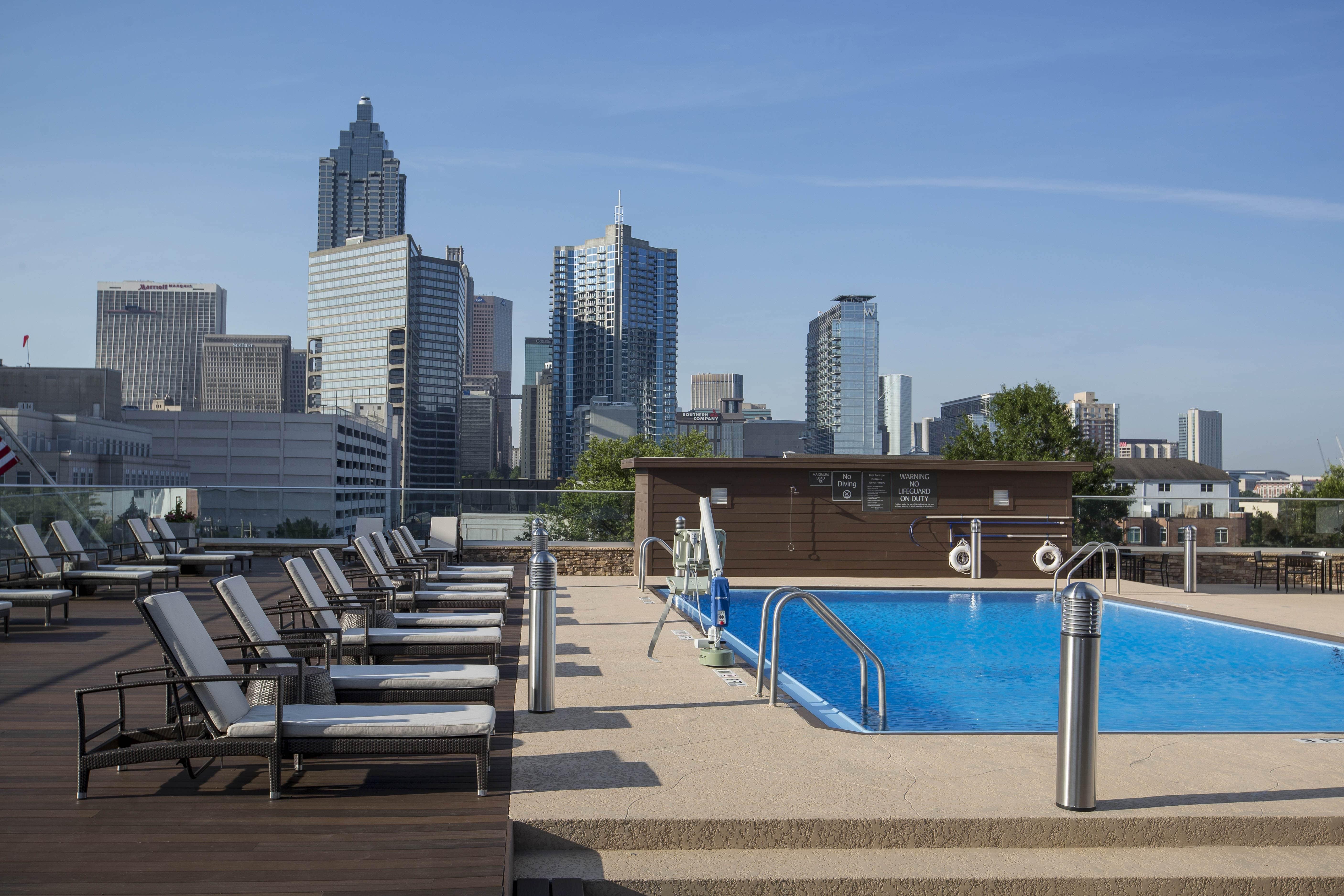 Chaise lounges surrounding rooftop pool at Crowne Plaza Atlanta Midtown.