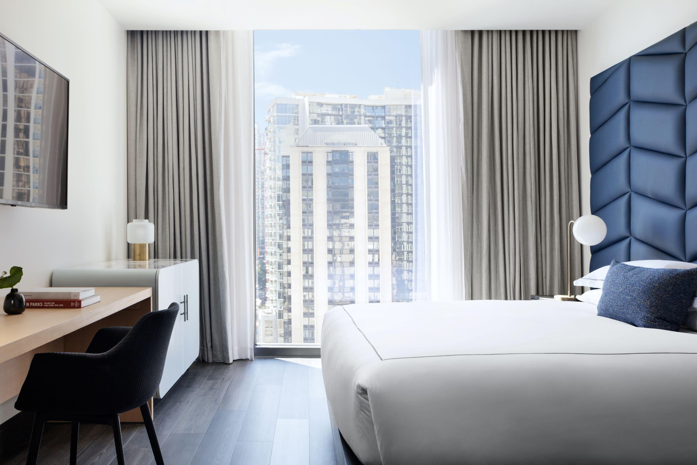 Modern room lit by natural light with city view at Kimpton Shane.