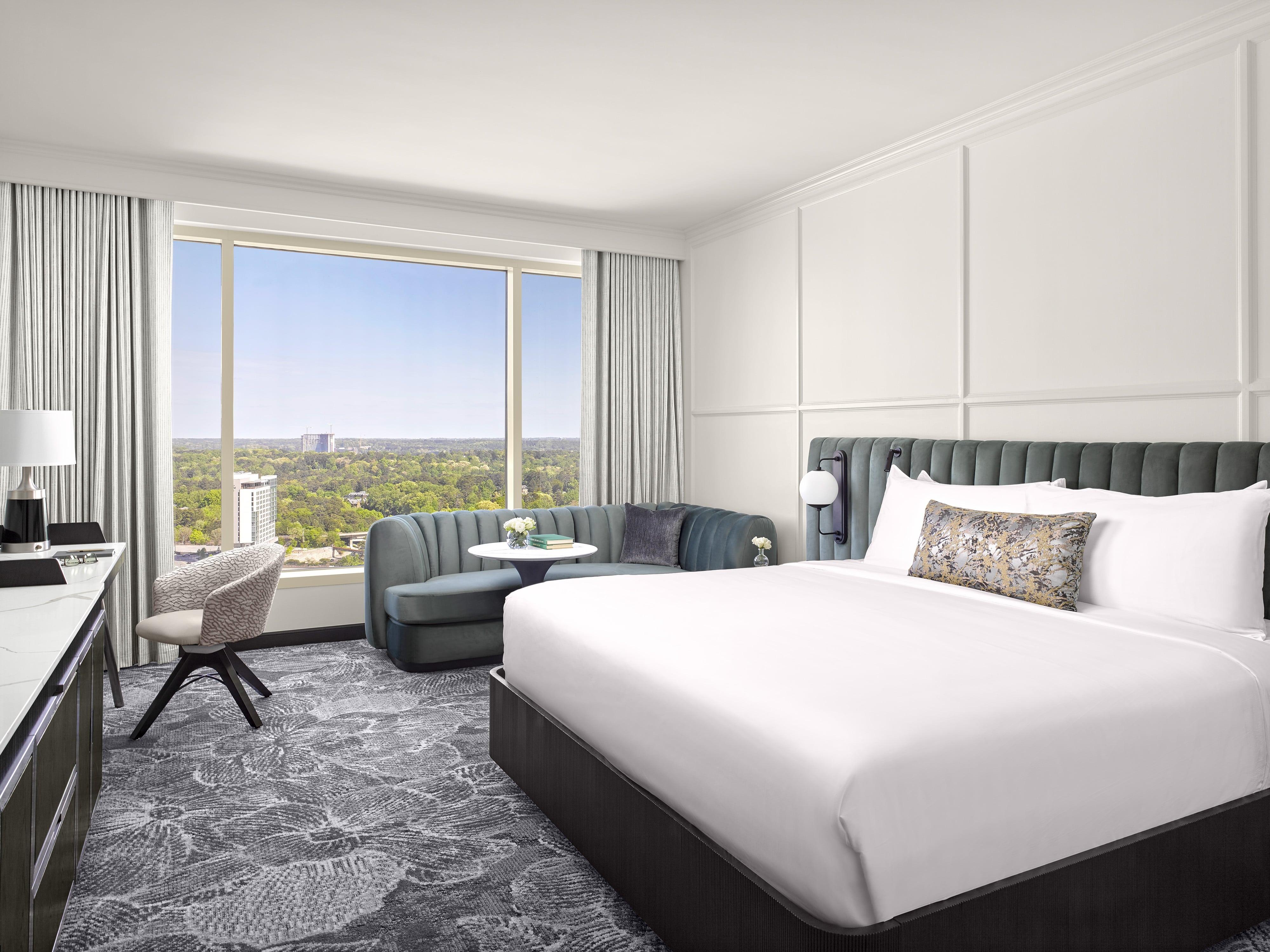 Sleek room with bed, sitting area and desk at InterContinental Buckhead Room.