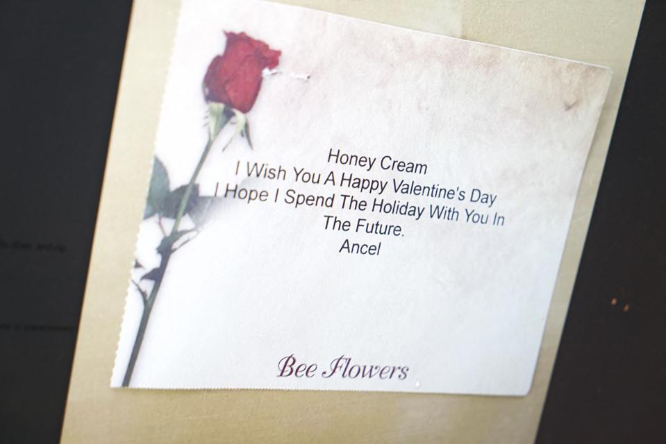 Fade paper with a picture of a rose and a romantic message "Honey cream"