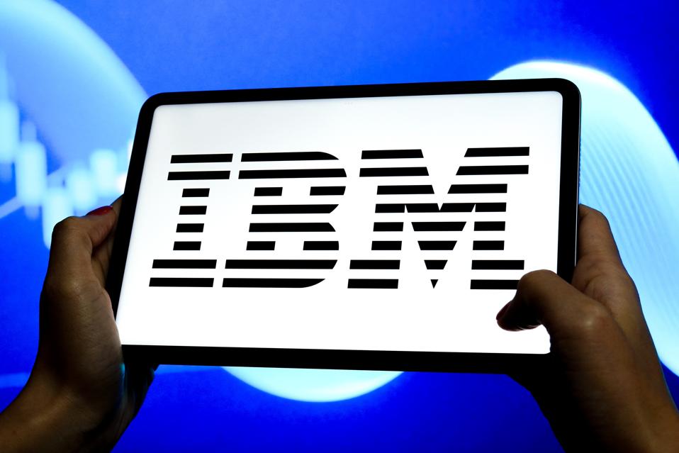 In this photo illustration, an IBM logo is seen displayed on...